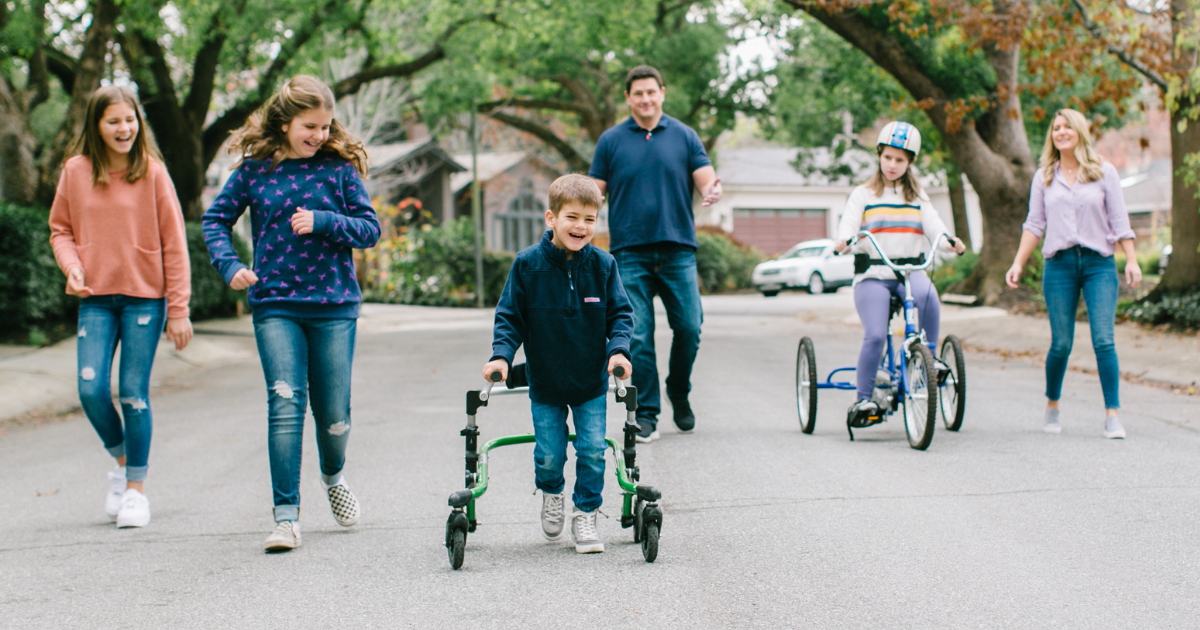Family and child with developmental epileptic encephalopathy taking a walk