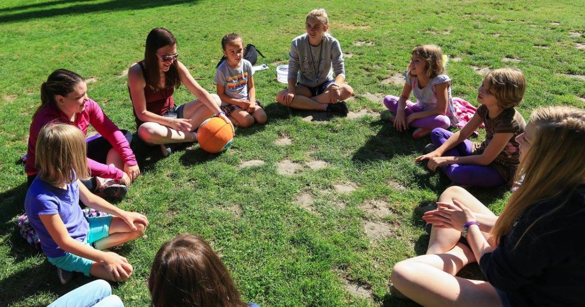 A group of campers sitting in a circle